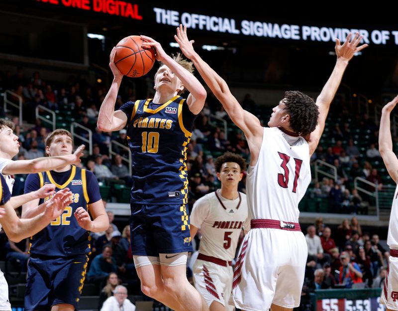 Pewamo-Westphalia's Grady Eklund (10) goes to the basket against Riverview Gabriel Richard's Bryce White (31), Thursday, March 13, 2025, in East Lansing.