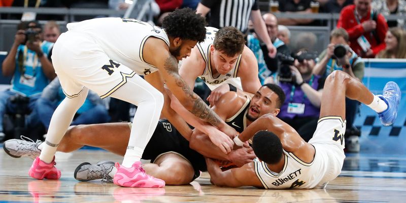 Michigan Wolverines guard Nimari Burnett (4), Michigan Wolverines forward Will Tschetter (42) and Michigan Wolverines guard Roddy Gayle Jr. (11) try to take the ball from Purdue Boilermakers forward Trey Kaufman-Renn (4) Friday, March 14, 2025, during the Big Ten Menâ€™s Basketball Tournament game at Gainbridge Fieldhouse in Indianapolis.