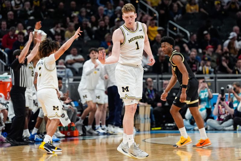 Michigan center Danny Wolf celebrates a 3-point basket against Purdue during the second half of a Big Ten Tournament quarterfinal at Gainbridge Fieldhouse in Indianapolis on Friday, March 14, 2025.