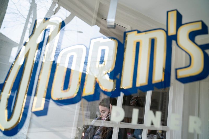 Emily Hanna, 30, of Detroit, reads her book as she waits on her egg breakfast at Norm’s Diner in Detroit’s West Village on Friday, March 14, 2025.