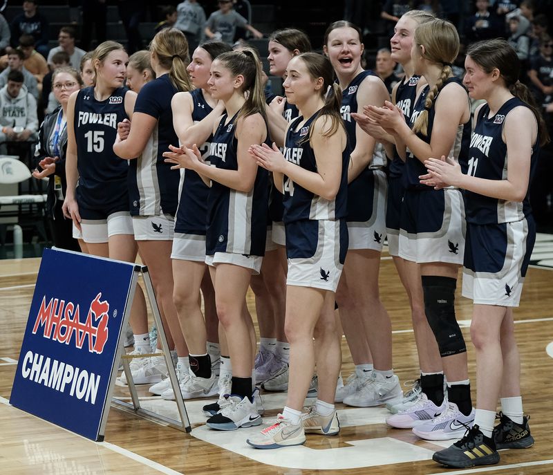 The Fowler High School Girls Basketball team line up to have their photos taken after defeating Ewen-Trout Creek for the Division 4 State Championship Saturday, March 22, at the Breslin Center.