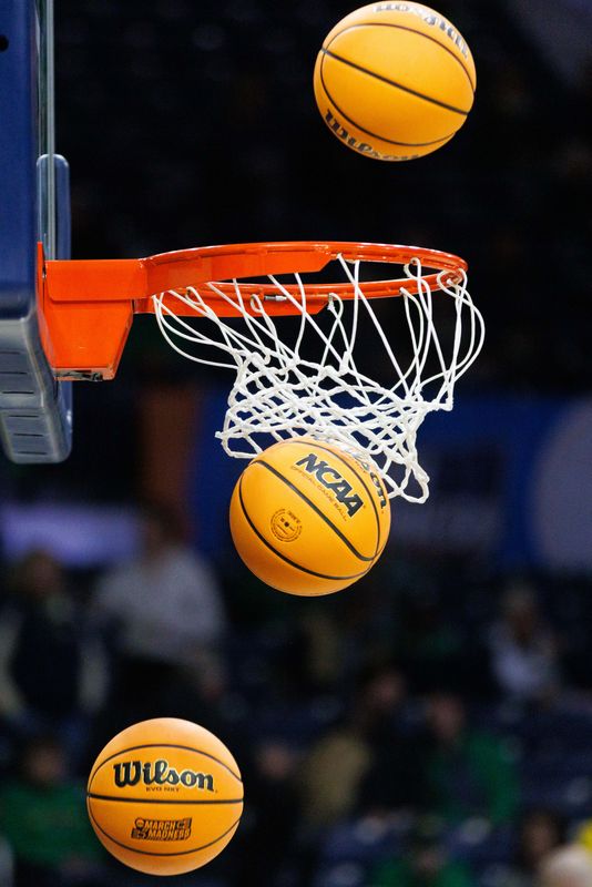 Balls fall through the hoop during warmups before the second round of the NCAA women's basketball tournament game between Notre Dame and Michigan at Purcell Pavilion on Sunday, March 23, 2025, in South Bend, Ind.