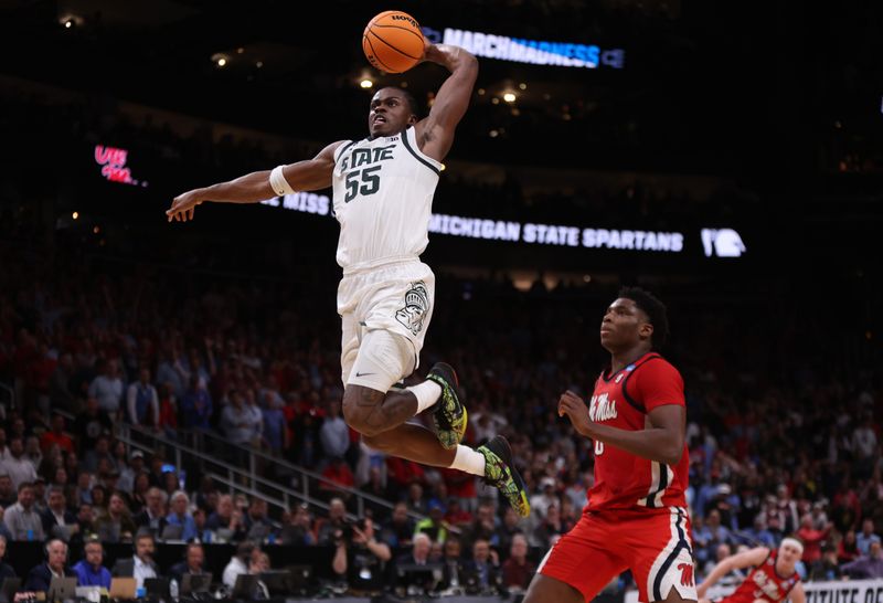 Mar 28, 2025; Atlanta, GA, USA; Michigan State Spartans forward Coen Carr (55) dunks against Mississippi Rebels forward Malik Dia (0) in the second half of a South Regional semifinal of the 2025 NCAA tournament at State Farm Arena. Mandatory Credit: Brett Davis-Imagn Images