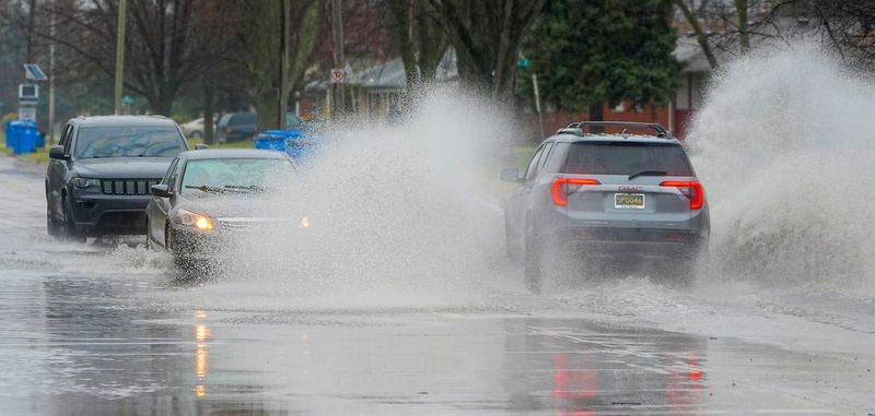 Heavy rains on Wednesday, April 2, 2025, in Dearborn Heights at Ann Arbor Trail and Glengary caused vehicles to drive slowly through a few inches of rain water that flooded the road.