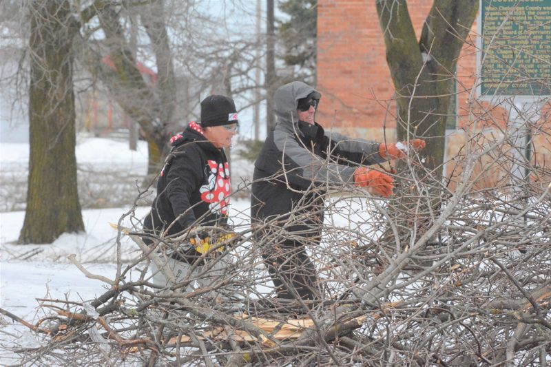 Cheboygan residents work to clear debris following the March 28-30 ice storm.