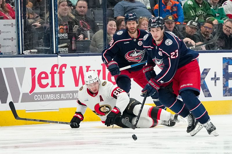 Columbus Blue Jackets center Sean Monahan (23) skates past Ottawa Senators defenseman Travis Hamonic (23) during the first period of the NHL hockey game at Nationwide Arena in Columbus on April 8, 2025.
