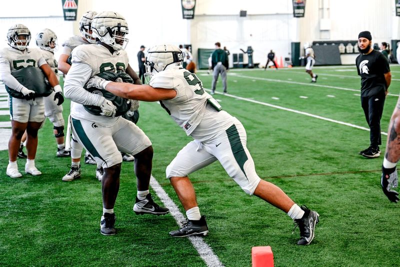 Michigan State's Derrick Simmons, right, and Quindarius Dunnigan work out with the defensive line during football practice on Tuesday, April 8, 2025, in East Lansing.