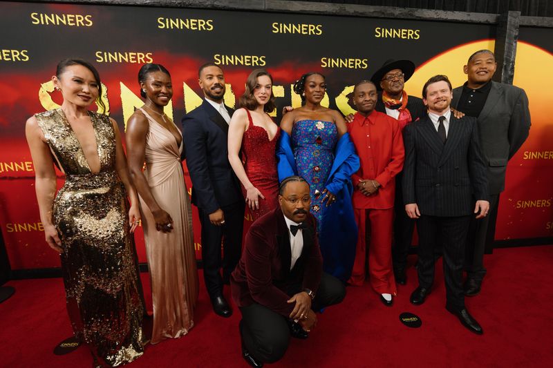 Ryan Coogler, front, kneels with the cast of "Sinners" at the film's New York City premiere.