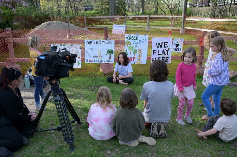Children of the neighborhood gather as Isaac Gourley, 12, talks about the importance of the park to him that is at the center of the Mies van der Rohe Historic District in Lafayette Park in Detroit on Monday, April 28, 2025.