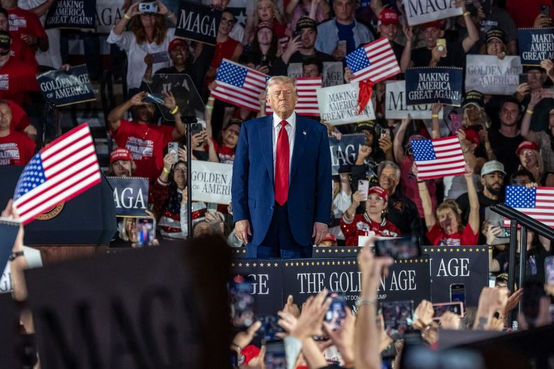 President Donald Trump takes the stage to speak to a crowd during his 100th Day in Office Achievement Rally at the Macomb on Tuesday, April 29, 2025.