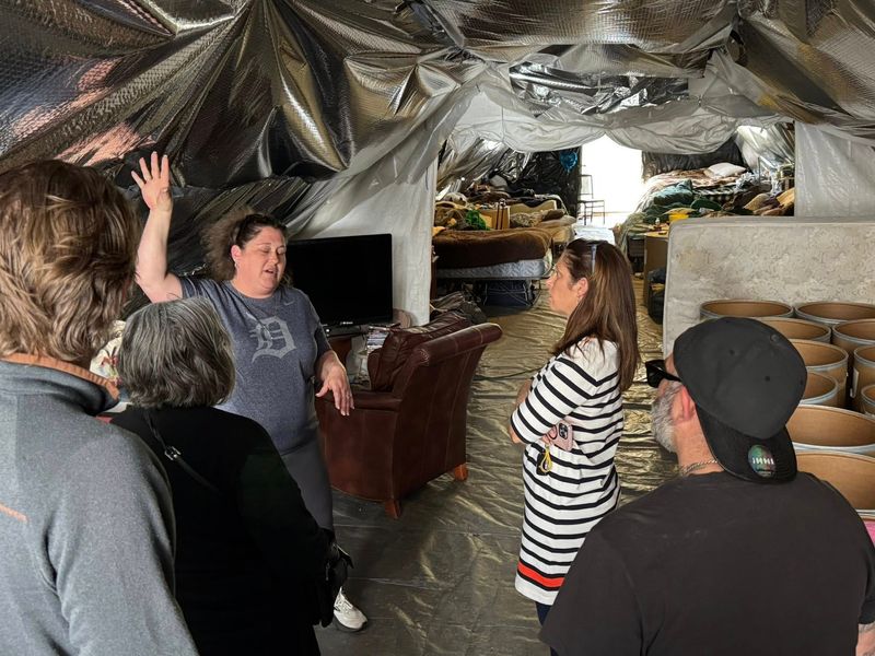 Missy Desjardin, left, explains how Camp Hope was able to house Hillsdale's homeless to State Rep. Jennifer Wortz (R-Quincy) (center) on Monday, April 28.