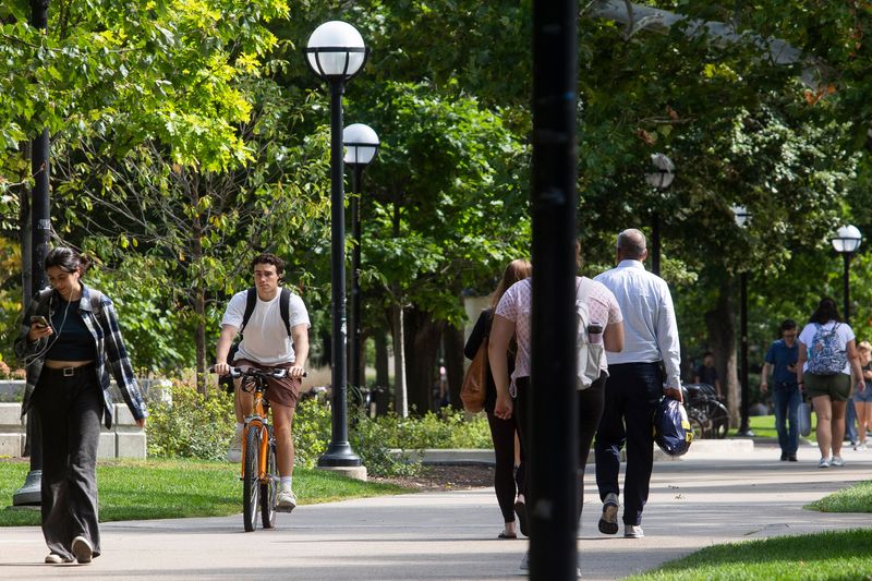 University of Michigan students walk across the "Diag" on campus on Thursday, Sept. 21, 2023 in Ann Arbor.