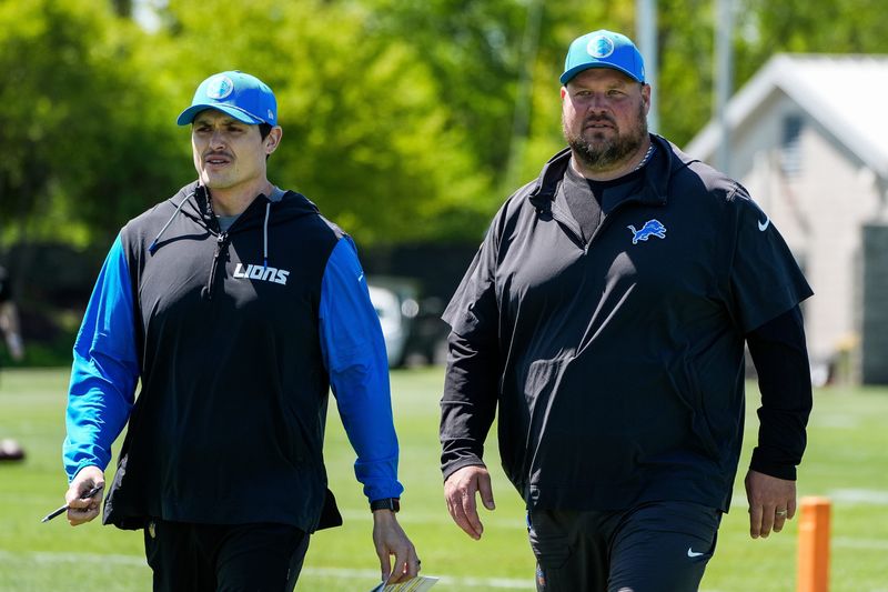 Detroit Lions assistant offensive line coach Steve Oliver, left, run game coordinator and offensive line coach Hank Fraley walk off the field after practice during rookie mini camp at Meijer Performance Center in Allen Park on Friday, May 9, 2025.