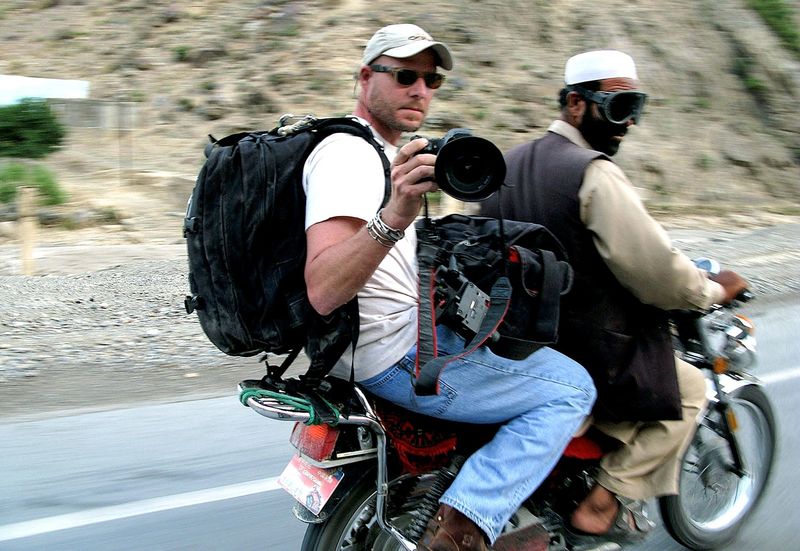 NPR Staff Photographer David P. Gilkey makes photographs from the back of a motorcycle taxi May 31, 2008 in Afghanistan.