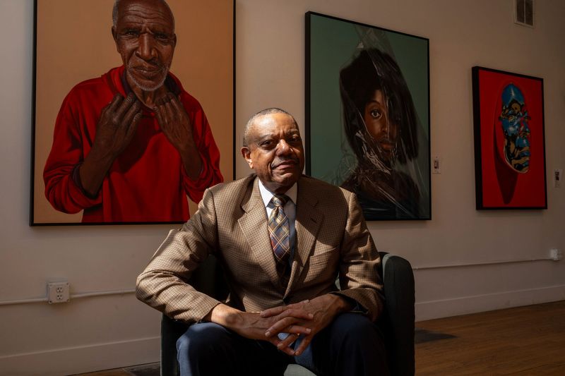 Oliver Ragsdale Jr., president and CEO of the Carr Center, with artworks featured in the “Everyday People” exhibit at the center in April 2025.