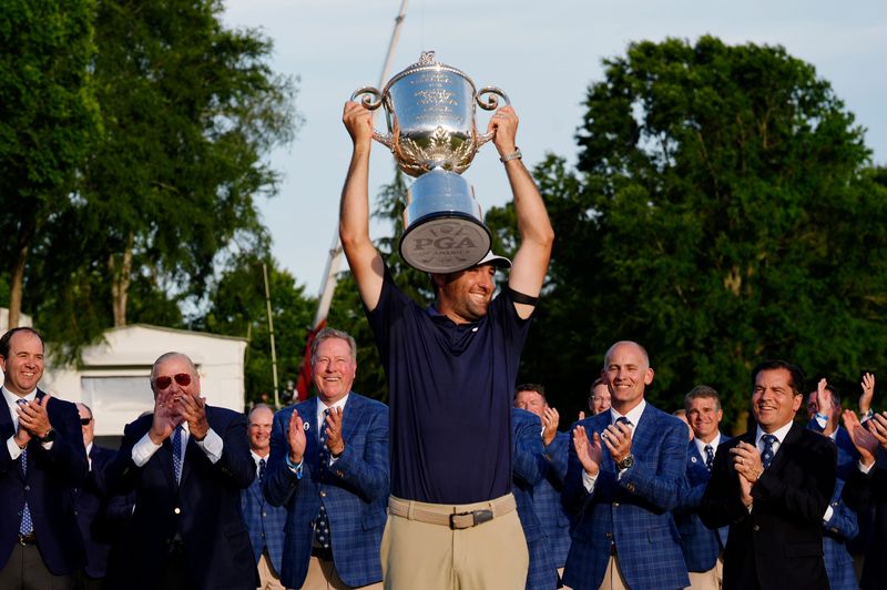 Scottie Scheffler holds up the Wanamaker Trophy after winning the 2025 PGA Championship at Quail Hollow Club.