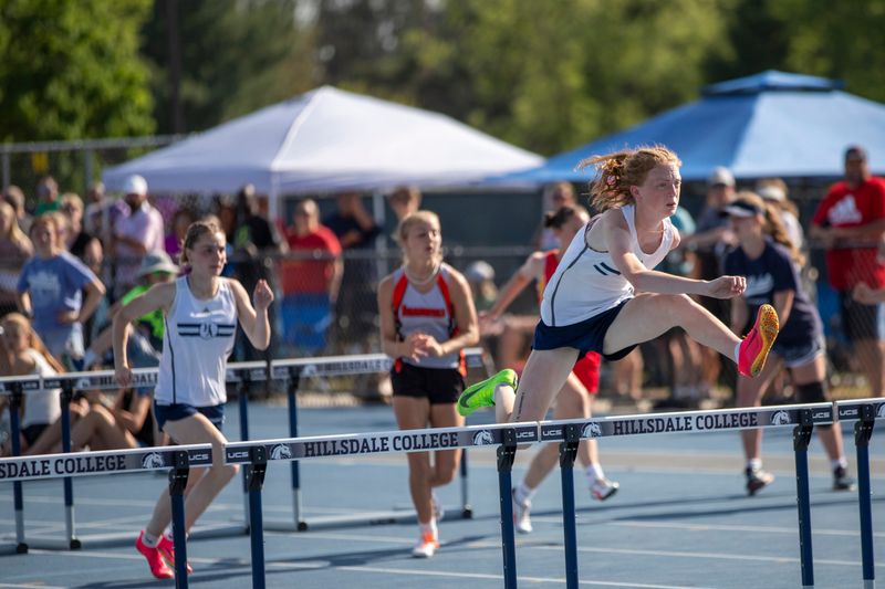 Academy junior Lucy Cote (right) leads the early 2026 area best meet standings for Hillsdale County girls track and field events.