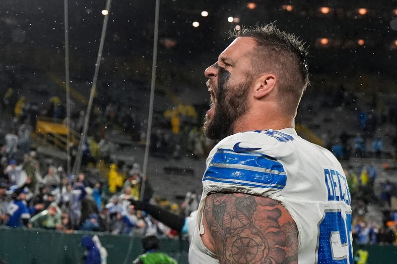 Detroit Lions left tackle Taylor Decker celebrates the 24-14 win over the Green Bay Packers as he exits the field at Lambeau Field in Green Bay, Wisconsin, Sunday, Nov. 3, 2024.