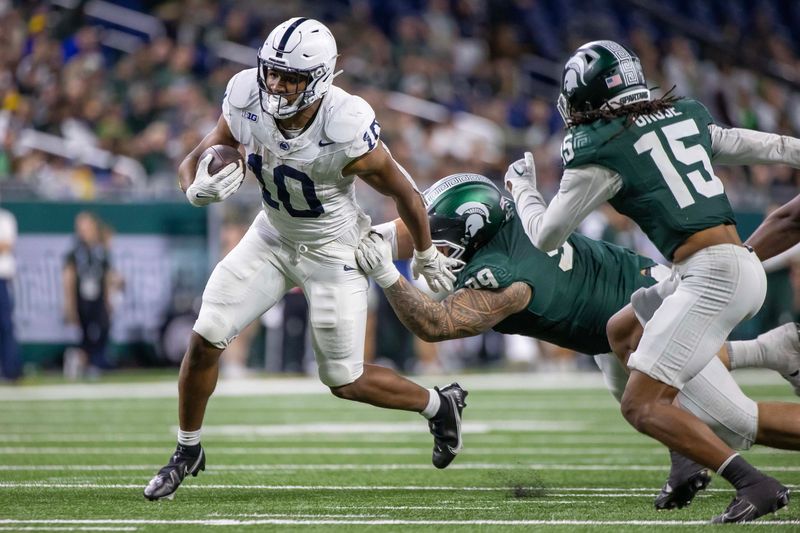 Nov 24, 2023; Detroit, Michigan, USA; Penn State Nittany Lions running back Nicholas Singleton (10) runs with the ball against the Michigan State Spartans during the second half at Ford Field. Mandatory Credit: David Reginek-USA TODAY Sports