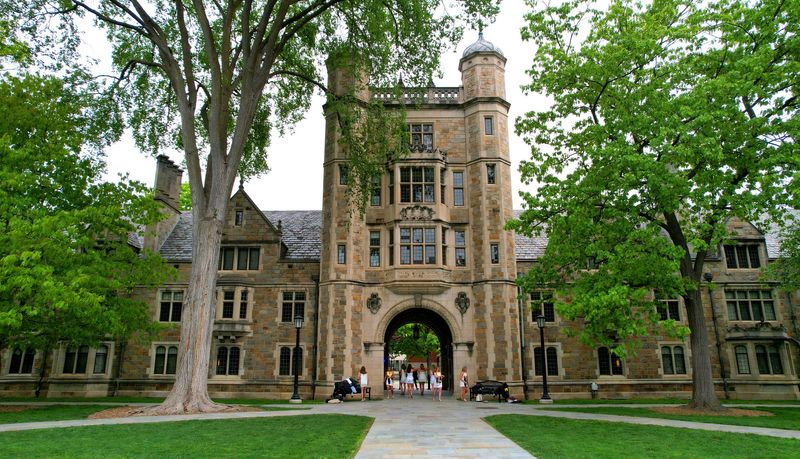 University of Michigan graduates leave the central passageway at the William W. Cook Law Quadrangle on Tuesday, May 20, 2025 after having their graduation pictures taken in the archway where six corbels of past U of M presidents can be found on campus in Ann Arbor.