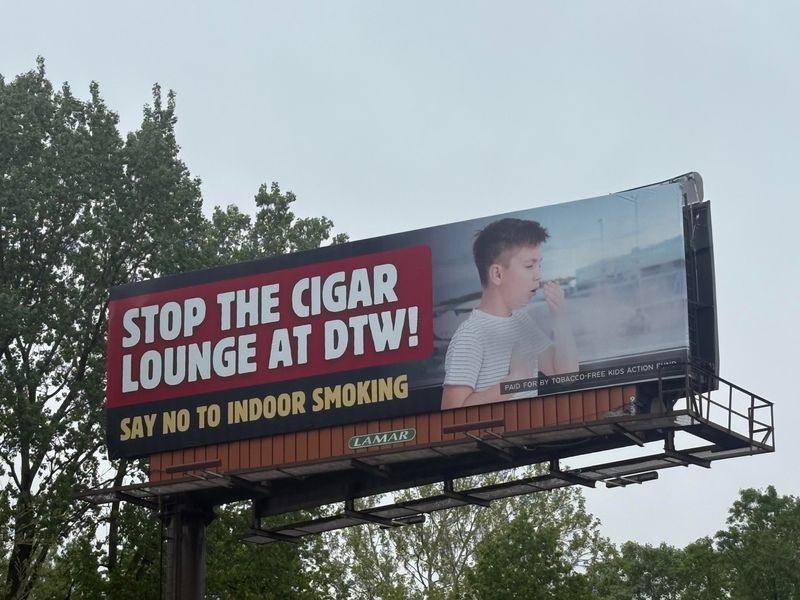 Public health coalition unveils a billboard campaign to oppose the proposed cigar lounge at the Detroit Metro Airport.