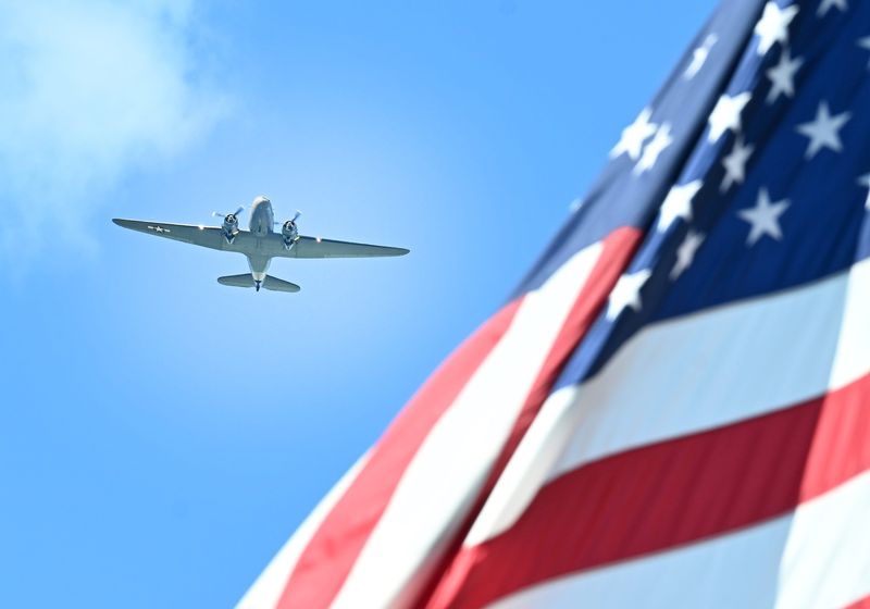 A bomber flies overhead over Michigan Avenue during the 99th year for the Dearborn Memorial Day Parade in Dearborn, Michigan on May 26, 2025.