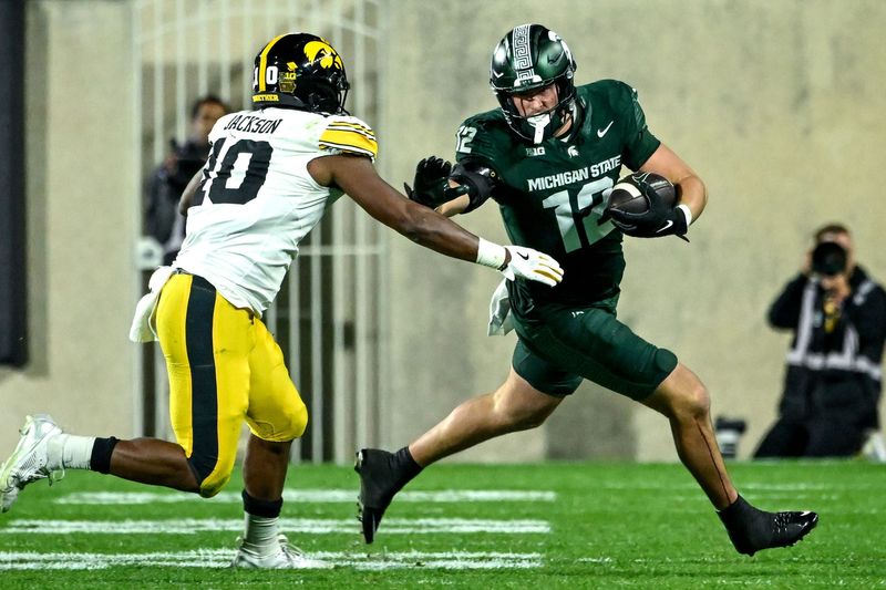 Michigan State's Jack Velling, right, runs after a catch as Iowa's Nick Jackson closes in during the third quarter on Saturday, Oct. 19, 2024, at Spartan Stadium in East Lansing.