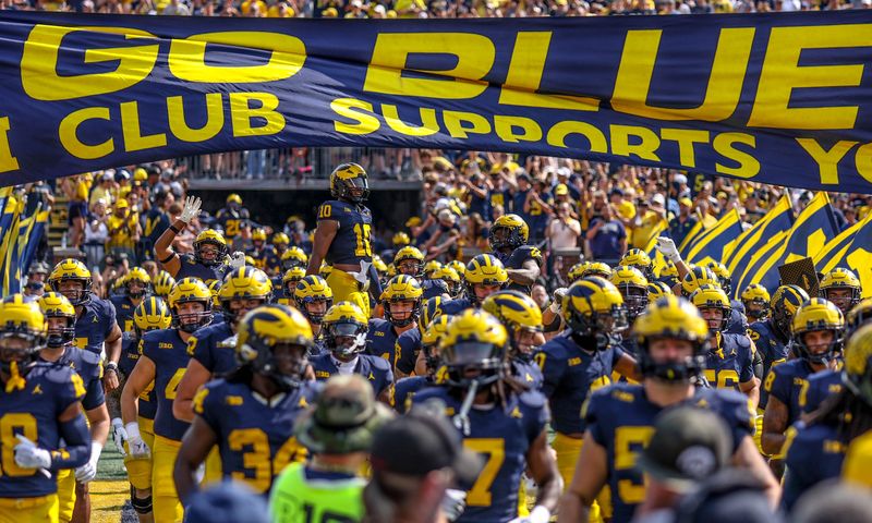 Michigan touches the banner before Arkansas State