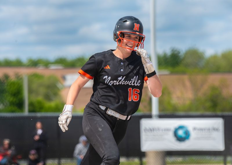 Northville's Jocelyn Burns celebrates smacking a grand slam during the Division 1 softball district championship on Saturday, May 31, 2025, at Salem High School.