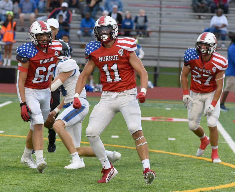 Tanner Collett of Monroe celebrates after sacking Lincoln quarterback Caden Greene on Friday, September 8, 2023. Other players Nolan Cacioppo and Adam Nabozny (27).