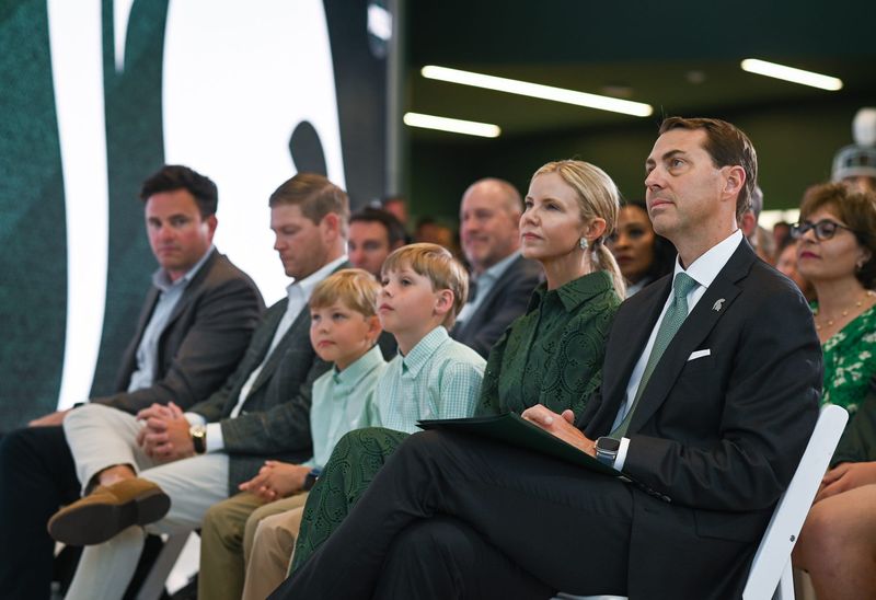 Michigan State Univeristy Athletic Director J Batt, right, listens to MSU basketball coach Tom Izzo, Wednesday, June 4, 2025, before being introduced to the Spartan community as the new athletic director. Seated next to Batt is wife Leah, and sons Fitzgerald and Graham.