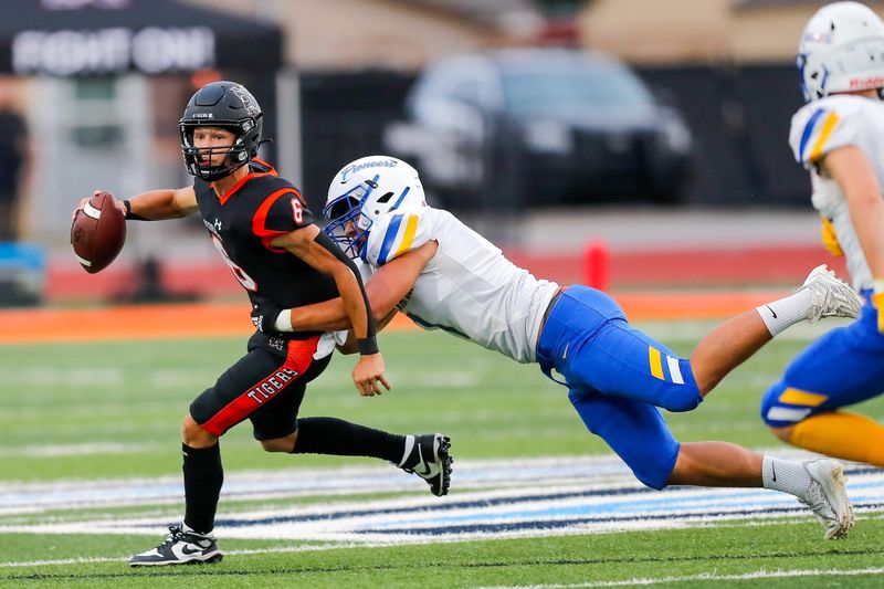 Normanâ€™s Phoenix Murphy (6) is sacked by Stillwaterâ€™s Nehemiah Kolone (7) during a high school football game between Stillwater High School and Norman High School in Norman, Okla., on Thursday, Sept. 14, 2023.