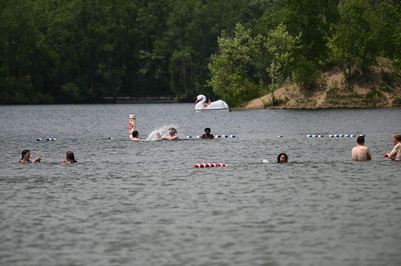 People swim at Hawk Island Park, Tuesday, June 5, 2025.