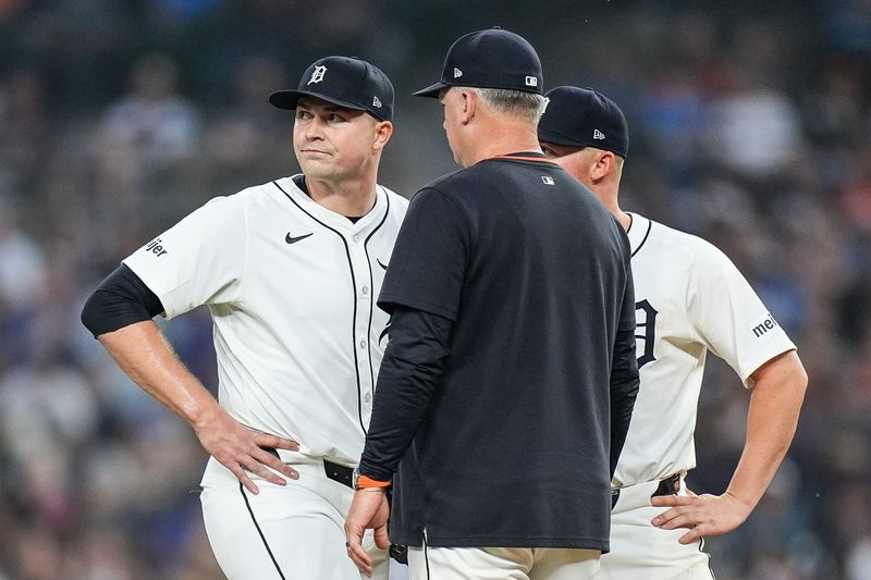 Detroit Tigers manager A.J. Hinch (14), right, talks to pitcher Tarik Skubal (29) for a pitching change during the eighth inning against Chicago Cubs at Comerica Park in Detroit on Friday, June 6, 2025.