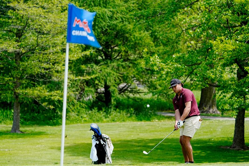 Ian Masih of Okemos High School chips on the 18th green during the 2025 MHSAA LP Division 1 Boys Golf Finals at Forest Akers West at Michigan State University in East Lansing on Saturday, June 7, 2025.
Masih won the individual championship with Jack Whitmore of Detroit Catholic Central coming in second.