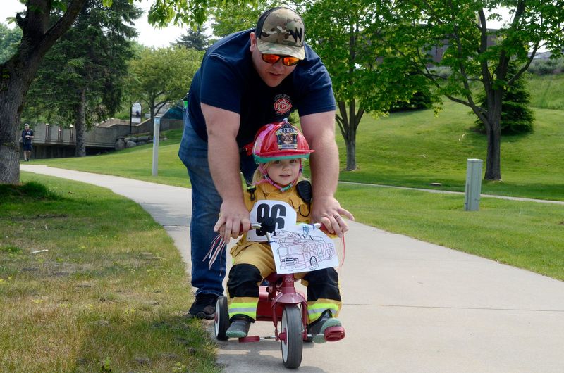 Cassie Bean, 3, of Petoskey gets some help from her dad, Peter, during the Third Annual Lynn Duse Memorial Kids’ Bike Fest in Petoskey on Saturday, June 7, 2025.