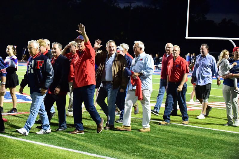 Members of the 1975 Livonia Franklin football team celebrate being inducted into the Athletics Hall of Fame on Friday, Sept. 15, 2023.