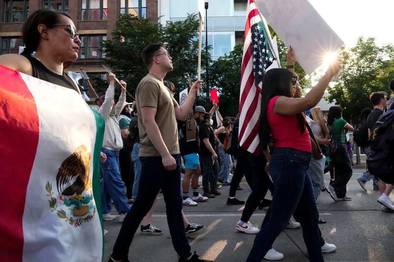 Protesters march against the Trump administration immigration policy and ICE deportations through streets of downtown Columbus after gathering at City Hall on Tuesday.