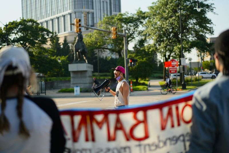 Justin Cheong, 35, a Chinese immigrant who now lives in Detroit, leads a protest against the Trump Administration at the Detroit Public Safety Building in Detroit on Wednesday, June 11, 2025. Cheong said, “I’m here to defend immigrant rights against ICE gestapo attacks and to shut down the Trump facism movement.”