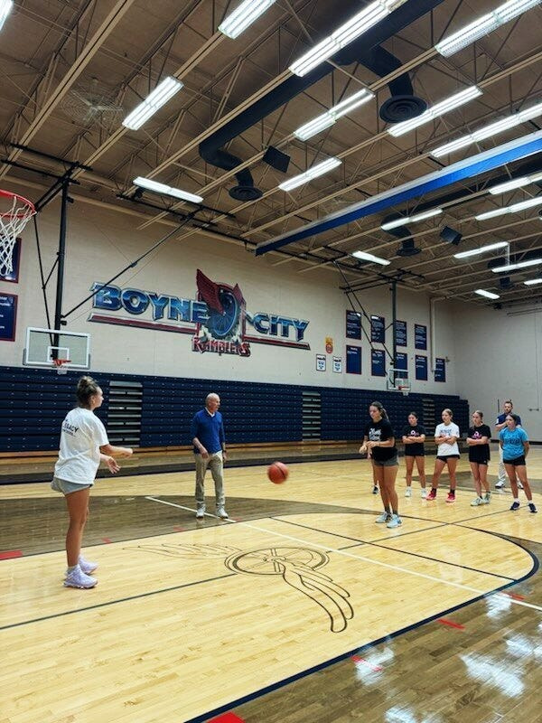 Former University of Michigan men's basketball coach John Beilein works with Boyne City girls basketball players in a session last summer in the Boyne City High School gym.