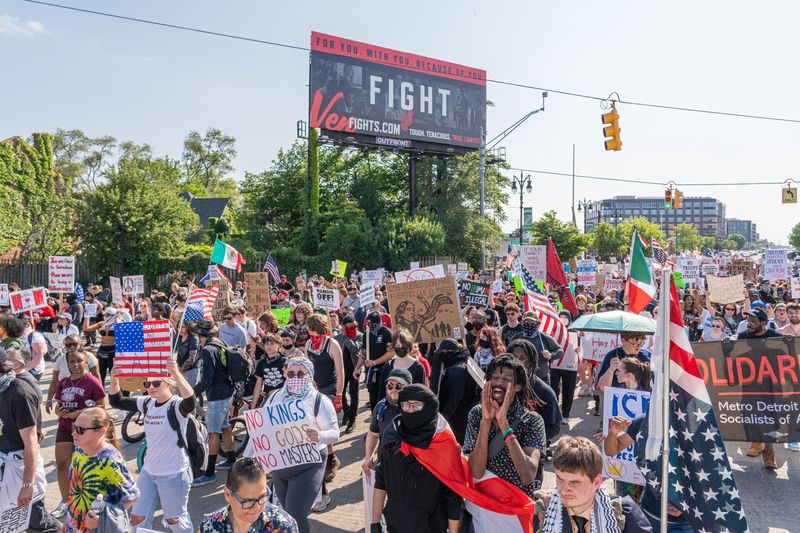 Protesters march down Michigan Ave. during a No Kings protest in Detroit on Saturday, June 14, 2025.