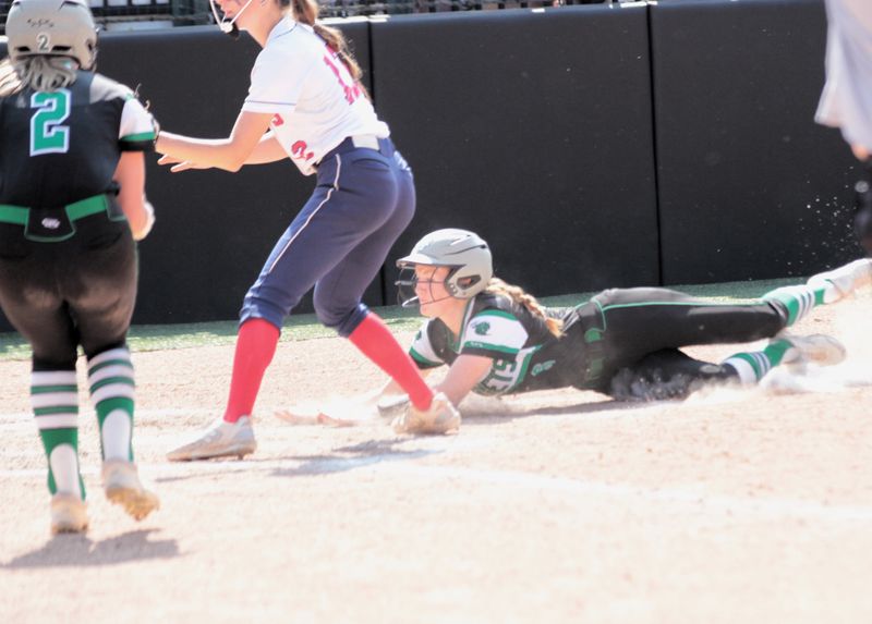 Brooke Gerth scores the state championship winning run for Mendon on Saturday.