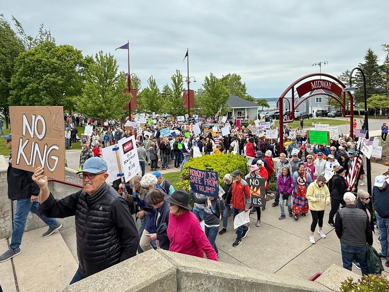 Protesters march from Bayfront Park toward downtown Petoskey on Saturday, June 14, 2025, during the No Kings Day demonstration.