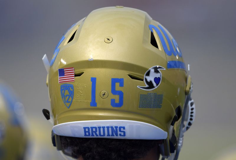Sep 3, 2017; Pasadena, CA, USA; UCLA Bruins defensive lineman Jaelan Phillips (15) wears Hurricane Harvey sticker on helmet during a NCAA football game against the Texas A&M Aggies at Rose Bowl. The sticker features the state of Texas inside the symbol for a hurricane and a heart over where Houston is located on the state map. Mandatory Credit: Kirby Lee-USA TODAY Sports