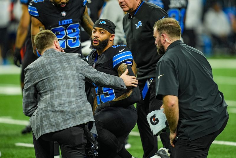 Detroit Lions cornerback Carlton Davis III is looked at after getting injured during a play against the Buffalo Bills at Ford Field in Detroit Sunday, Dec. 15, 2024.