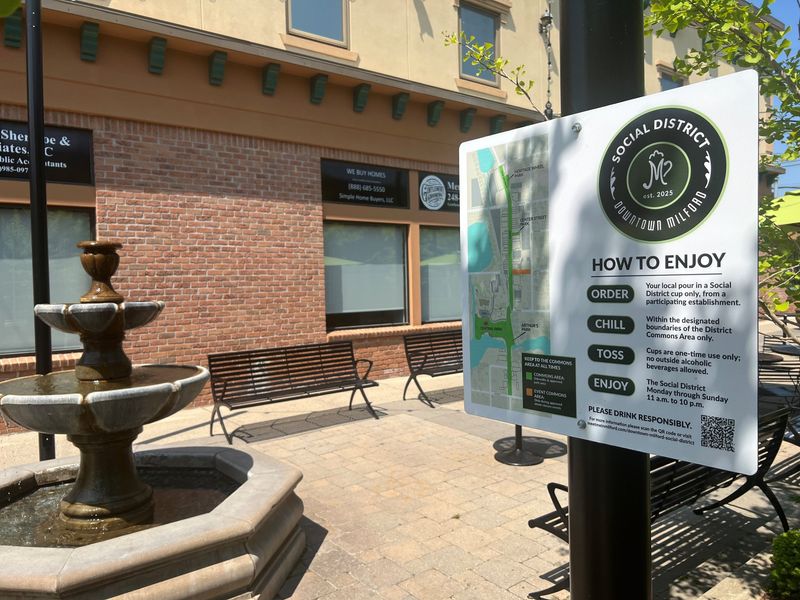 Signage at Center Street Park in Milford explains the social district and is accompanied by a map showing the areas where alcoholic beverages purchased from participating businesses can be enjoyed.