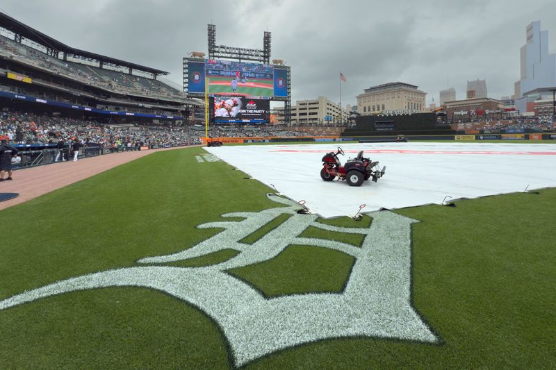 A tarp covers the infield during a rain delay before the game between the Detroit Tigers and the Pittsburgh Pirates at Comerica Park in Detroit on Thursday, June 19, 2025.