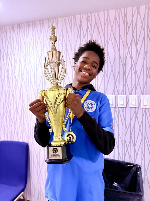 This Just In: The Detroit City Chess Club (DCCC) wins the inaugural Great Lakes International Youth Chess Cup in Toronto, as a result of multiple individual victories registered by DCCC team members, including Erick Nelson, a rising 10th grader at Cass Tech, who was photographed Sunday morning holding the first-place trophy he won in the U700 Section. "I'm incredibly proud of our students for winning the inaugural Great Lakes International Youth Cup," said DCCC founder Kevin Fite, whose team boarded a bus in Toronto on Sunday loaded with individual trophies and medals, and one large team trophy cup that DCCC will retain until the next Great Lakes International Youth Cup. "This victory is a testament to the hard work of our players, the unwavering support of our families, and the strength of our DCCC community. I also like to thank the Toronto Chess Club for creating such a memorable international experience for our young people. This was more than a tournament, it was a celebration of unity, competition and growth."