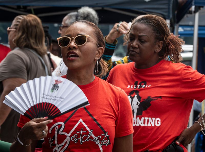 Tanny Prophile of White Plains, N.Y. uses a portable fan to stay cool as she attends the African-American Cultural Celebration at Kensico Dam Plaza in Valhalla, N.Y. June 22, 2025. Temperatures approached 90 degrees in the Lower Hudson Valley on Sunday and will remain in 90's through Wednesday.