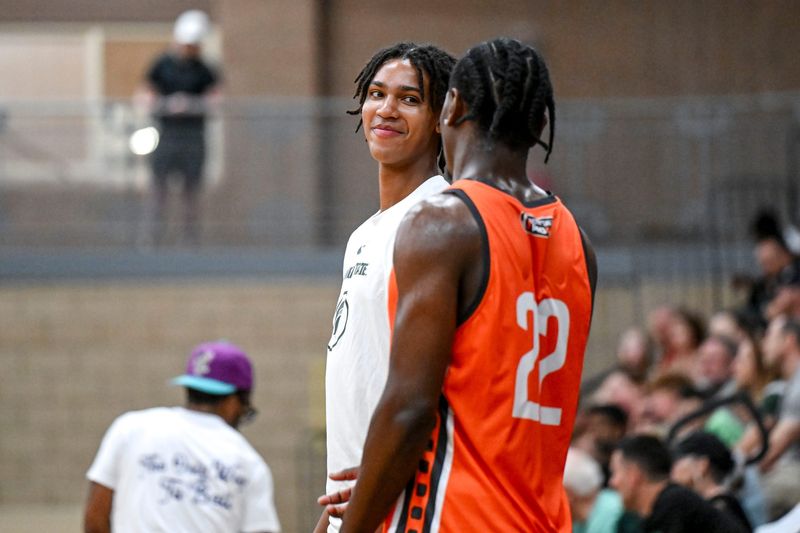 Michigan State's Jordan Scott, left, talks with MSU and Team Snipes teammate Trey Fort during the Moneyball Pro-Am on Tuesday, June 24, 2025, at Holt High School.